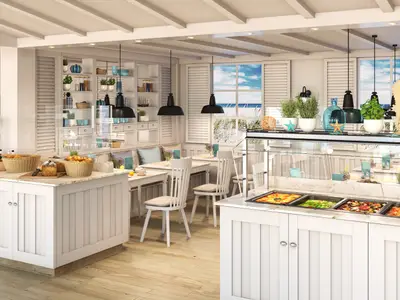 Das helle Beach House Restaurant an Bord der AIDAcosma. Es zeigt Buffettheken mit Speisen, weisse Tische und Stühle. Maritime Dekoration und Fenster mit Meerblick schaffen eine entspannte Atmosphäre.