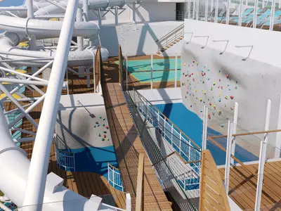 Ansicht des grossen Aktivitaetendecks der AIDAcosma mit weissen Wasserrutschen, einer farbigen Kletterwand, einem Sportfeld und einem Seilgarten über dem Meer. Ohne Personen.