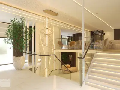 Ein modernes, helles Atrium auf der Amadeus Aurea mit einer breiten, beleuchteten Treppe, hohen goldenen Pendelleuchten, einer grossen Zimmerpflanze und gemütlichen Lounge-Bereichen auf mehreren Ebenen.