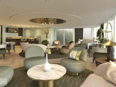 Innenansicht der modernen Bar-Lounge auf der AMADEUS Mira mit grünen und beigen Sesseln, hellen Tischen, einer langen Bar mit Hockern und großen Fenstern, die ins Grüne blicken. 