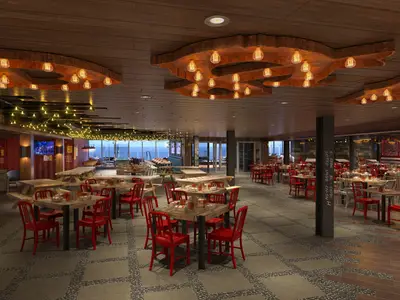 Gerendertes Bild eines großen, modernen Restaurants der Carnival Celebration mit Holzboden und Steinfliesen. Es gibt viele Tische mit roten und silbernen Stühlen. Große Fenster bieten Meerblick. Rustikale Holzdecken und Lichterketten schmücken den Raum.