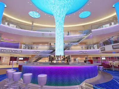 Innenansicht eines mehrstöckigen Atriums auf der Carnival Horizon mit einer runden Bar in der Mitte, umgeben von Hockern. Eine leuchtende, türkise Wassersäule reicht von der Bar bis zur Decke. Mehrere Ebenen mit Gelaendern und Treppen sind sichtbar. Die Einrichtung ist modern mit violetten und blauen Akzenten.