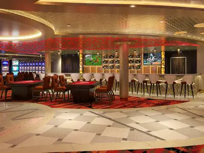 Weitwinkelaufnahme eines eleganten Casinos mit goldener Decke, roten Spieltischen, einer gut sortierten Bar und zahlreichen Slotmaschinen. Keine Personen sichtbar.
