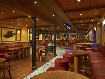Geräumige, gemütliche Bar auf der Carnival Sunshine mit rotem Ledergestühl und Holztischen. Im Hintergrund eine Theke und eine kleine Bühne mit Lichtanlage. Eine Palme und ein Hummer-Wandbild sind zu sehen.