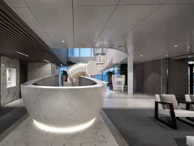 Modernes, luxuriöses Atrium mit Wendeltreppe, Rezeption, Marmor und eleganten Sitzgelegenheiten.