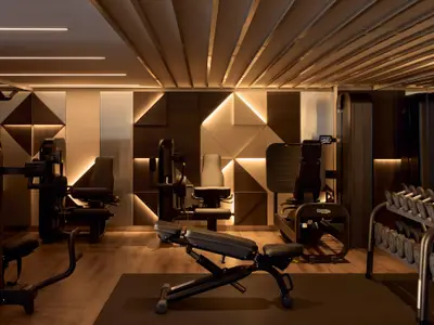 Moderner Fitnessraum an Bord der Explora I mit Technogym-Trainingsgeräten, Kurzhanteln und stilvoller Wandbeleuchtung.