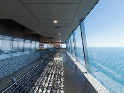 Blick über ein modernes Hallenbad mit schimmerndem Wasser und riesigen Fenstern aufs Meer an Bord der Explora III.
