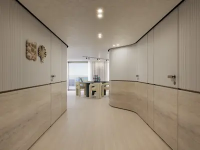 Geschwungener Flur mit hellen Holz- und Steinwandelementen in der Owner's Residence an Bord der Explora III mit Blick aufs Meer.