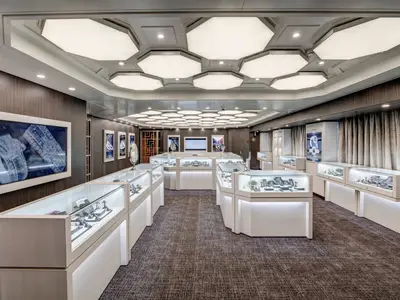 Der luxuriös gestaltete Schmuckladen an Bord der Noordam mit hell beleuchteten Vitrinen und sechseckigen Deckenleuchten.