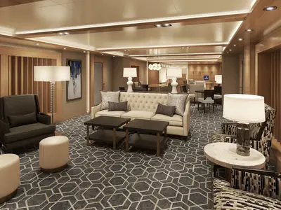 Ein elegant gestalteter Loungebereich an Bord der Rotterdam mit stilvollen Sofas, Sesseln und warmem Licht.