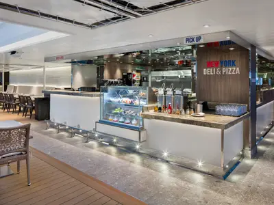 Der helle Counter des New York Deli & Pizza Restaurants an Bord der Rotterdam mit einer gefüllten Glassvitrine.