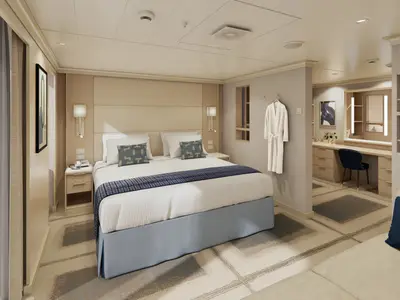 Modern eingerichtete Signature Suite an Bord der Rotterdam mit Doppelbett, Schminktisch und hellem Holzdekor.