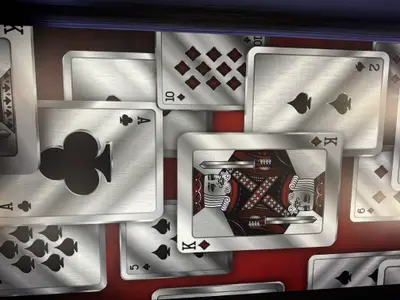 Nahaufnahme eines dekorativen Wanddesigns mit verschiedenen Spielkarten-Motiven wie dem Karo-König an Bord der MSC Euribia.