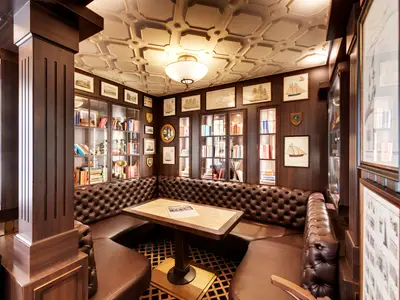 Ein gemuetlicher Pub an Bord der MSC Grandiosa. Dunkles Holz, braune Lederbänke und ein Tisch. Die Waende sind mit Buechern und nautischen Bildern dekoriert.