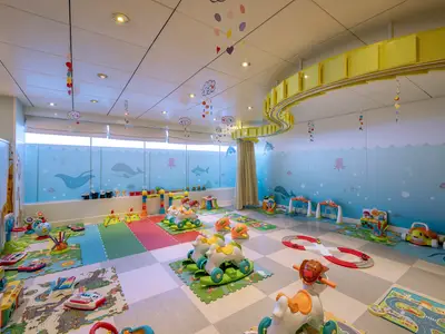 Der farbenfrohe Kinderbereich an Bord der MSC Lirica. Wände mit Meerestieren, bunte Spielmatten, Schaukelpferde und viele weitere Spielsachen laden Kinder zum Spielen ein. Der Raum ist hell und freundlich.