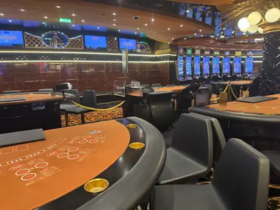 Blick auf die leeren Spieltische und Spielautomaten im glänzenden Casino an Bord der MSC Preziosa.