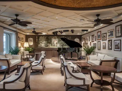 A grand piano sits on a stage in the elegant Raj Polo Tea House lounge on MSC World Europa, surrounded by comfortable seating and intricate artwork.