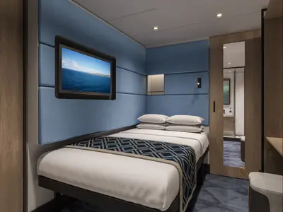 Moderne Innenkabine der Norwegian Aqua. Ein Bett mit blau-weißem Muster, blaugepolsterte Wände, TV mit Meerblick. Rechts Holztür zum Bad.