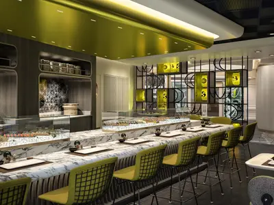 Eine moderne Sushi-Bar im Spezialitätenrestaurant Nama an Bord der Norwegian Aqua, mit einer langen Marmortheke, leuchtend gelben Stühlen und einer Auslage mit Sushi und Sashimi auf Eis. Im Hintergrund sind dunkle Holzwände mit geometrischen Mustern und gelb leuchtende Laternen zu sehen.