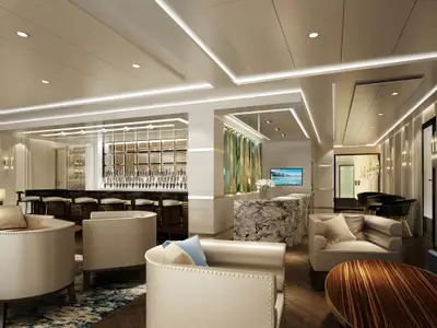 Elegante Bar-Lounge an Bord der Norwegian Encore mit langer Bar, gefüllten Regalen, bequemen Sesseln und Marmortresen. Moderne indirekte Beleuchtung.