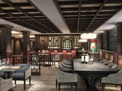 Die stilvolle The Cellars Wine Bar an Bord der Norwegian Encore, mit dunklem Holz, roten Akzenten, modernen Möbeln und zahlreichen Weinflaschen in Regalen.