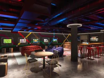 Moderne Gaming-Lounge 'Entourage' an Bord der Norwegian Encore. Bequeme Sofas, Spielbildschirme, hohe Tische mit roten Barhockern und farbige Beleuchtung sind zu sehen. Die Wände sind mit einem Linienmuster verziert. Der Raum ist ohne Personen.