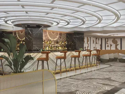 Die Metropolitan Bar an Bord der Norwegian Luna. Elegante Marmortheke, Art-déco-Motive, amberfarbene Barhocker und ein bequemer Lounge-Bereich mit gemustertem Teppich.