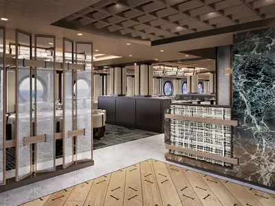 Innenansicht des modernen Commodore Restaurants an Bord der Norwegian Luna. Elegante Trennwände, Holzböden und Marmorakzente prägen den Raum mit runden Fenstern und gedimmter Beleuchtung.