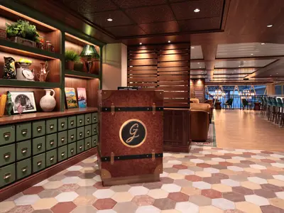 Innenansicht der Utopia of the Seas. Lounge mit Bücherregal, Tresen mit 'G'-Logo und Bar. Boden mit sechseckigen Fliesen in Erdtönen. Sitzbereiche hinten.